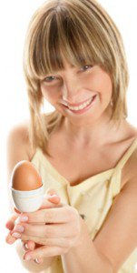 Woman smiling and holding an egg